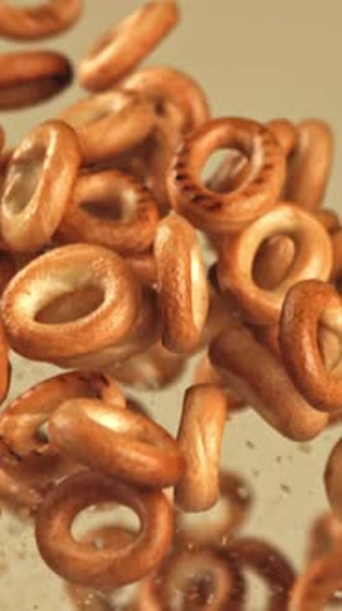 The Steering Wheel Crackers Fly Up and Fall on a Light Background Filmed on a Highspeed Camera at