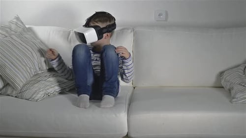 Boy wearing vr goggles reaches out in a modern studio environment