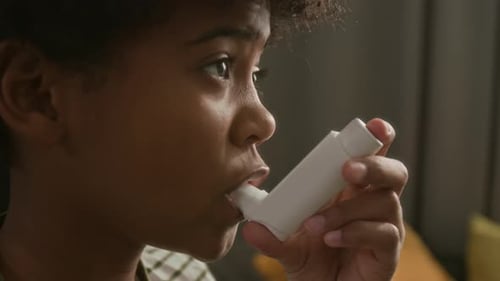 Close-Up of Little Boy Inhaling Asthma Medication at Home