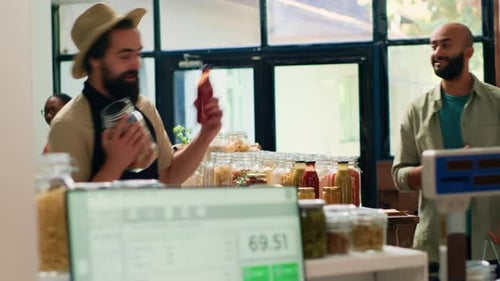 Store Employee Weighs Jars of Vegetables for Customer