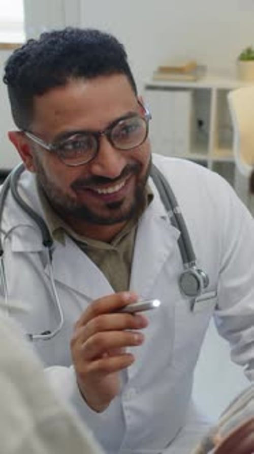 Caring Doctor Talking to Patient in Office