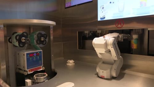 An automated robot arm makes a beverage drink for a customer by combines elements of engineering, ma