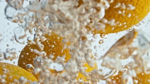 Fresh Lemons Sinking in Water with Bubbles