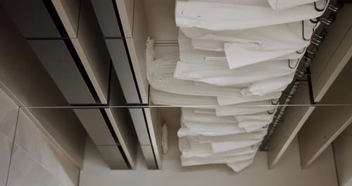 Interior wardrobe with shelves and white shirts