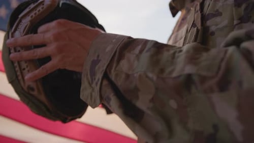 Soldier Saluting with Flag at Sunset or Sunrise