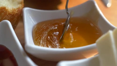 Close Up of Fresh Honey in a White Bowl