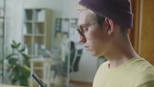 Gen Z Man Surfing The Internet on Smartphone in Office