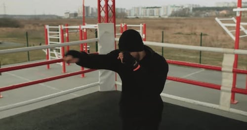 Man Boxing in an Outdoor Ring