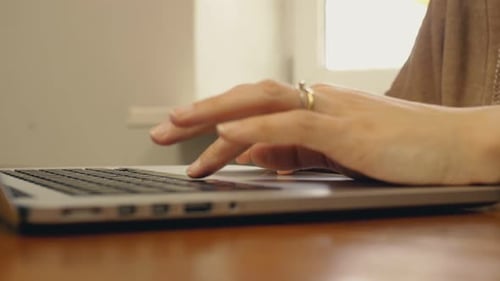 Woman Typing on Laptop Keyboard Close Up