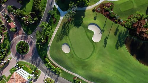 Drone aerial view looking down at a perfectly curated golf course putting green