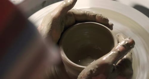 Hands Shaping Clay on a Pottery Wheel