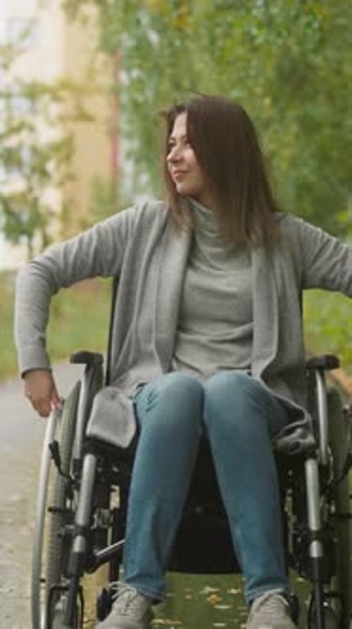 Woman with Paralysis Enjoys Rest in Green Park on Nasty Day