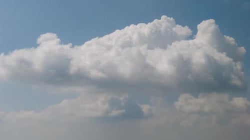 Fluffy White Clouds Drifting in a Blue Sky