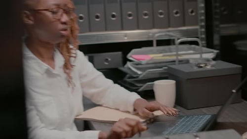 Woman Typing at Desk in Office Workplace