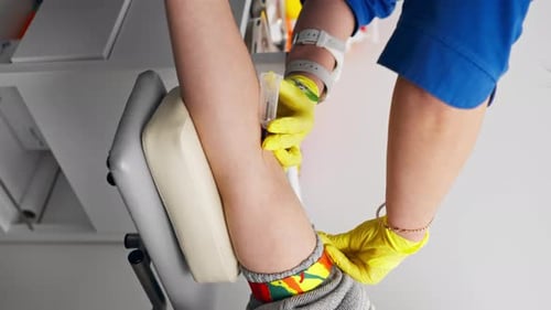 Vertical Video Close Up in the Clinic a Guy Asks a Doctor with a Blue Form for Blood Tests Healthy