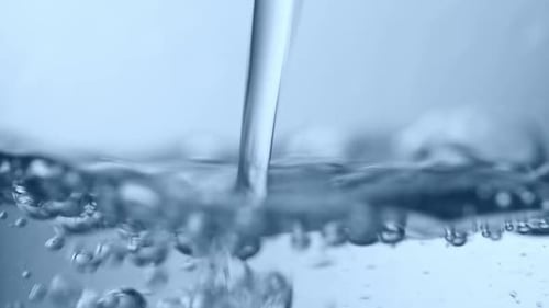 Clear Water Pouring Creates Bubbles and Ripples