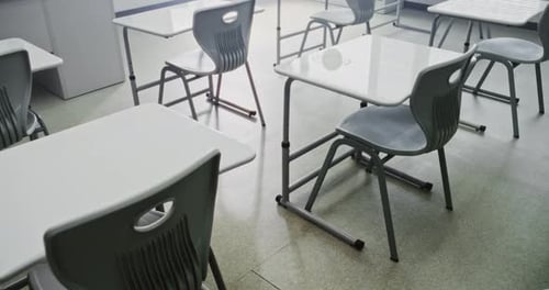 Interior of Modern Empty Elementary School Classroom with Working Desks and Chairs for Students