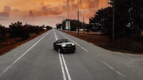 Car driving through hell afterlife to city of fire.
