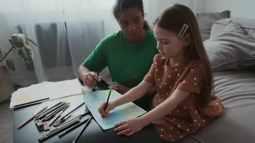 Nanny and Little Girl Drawing Together at Home