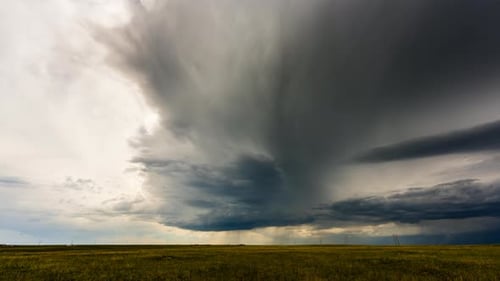 Dramatic Storm Clouds Over Grassy Field Time Lapse