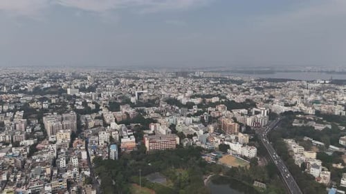 Aerial perspective of Hyderabad with dense housing clusters and surrounding vegetation.