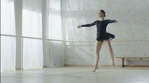 Gorgeous Young Ballerina Doing Pirouette in Slow Motion. Shot in a Bright Modern Studio on a Sunny