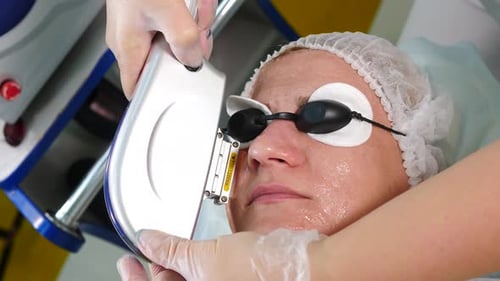 Skin Care Aesthetic Procedure in Modern Cosmetology Clinic Expert Beautician Using Phototherapy