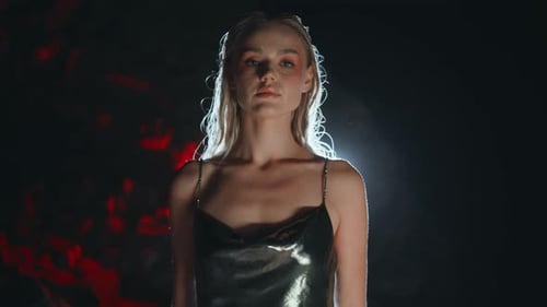 Young Woman Posing in Dark, Moody Lighting