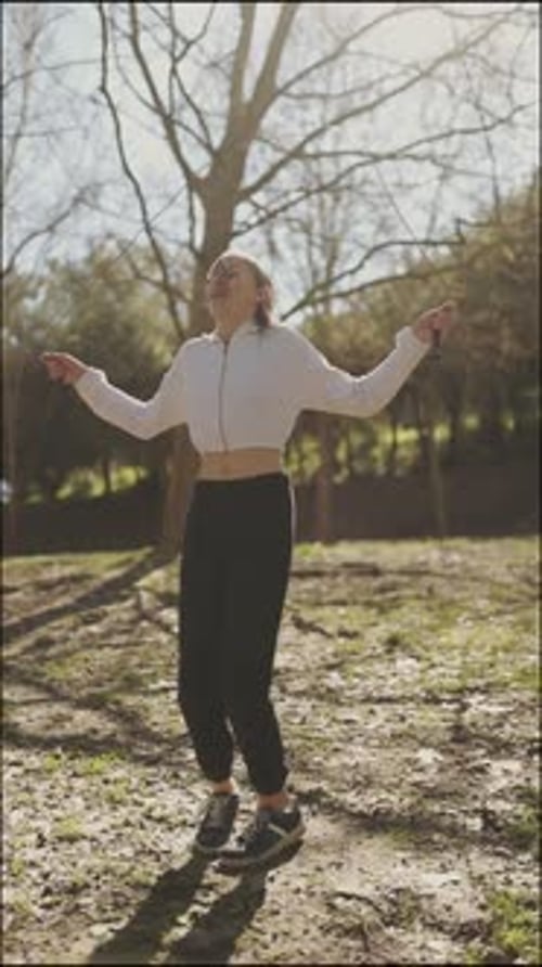 Young Woman Jumping Rope in Park