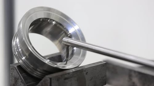 Close up view of Mototiyo inspecting engine part component