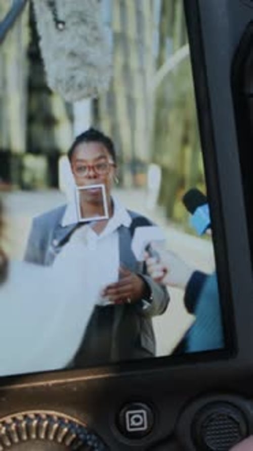 Woman Talking into Microphones at a Press Conference