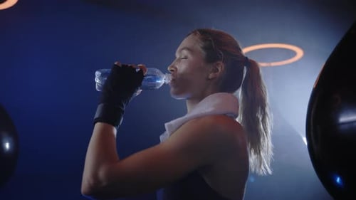 Woman Drinking Water After Intense Workout