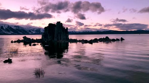 Beautiful tufa at Mono Lake reflecting in the water during a dramatic sunset. Ripples of water throu