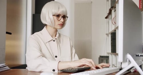 Young Business Woman in Glasses Working in Office Interior on Pc on Desk Typing