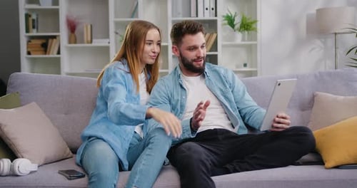Young Adults Chatting on Tablet at Home