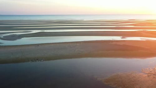 Shallow Low Tide Beach Aerial Drone Footage of Sand Bars and Water Puddles at Golden Hour, Sliding L