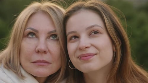 Smiling Women Embracing in Natural Outdoor Setting