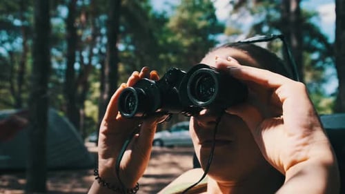 Woman Using Binoculars to Explore Nature Outdoors