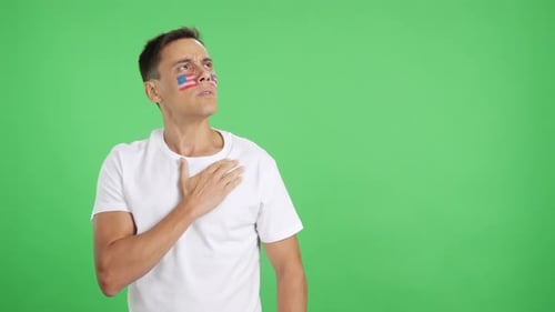 Adult Male With Flag Painted on Face Hand-on-Heart