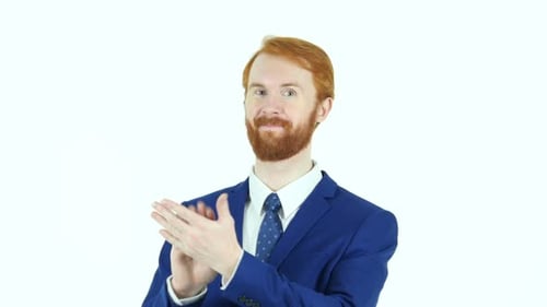 Man in Blue Suit Clapping Against White Background