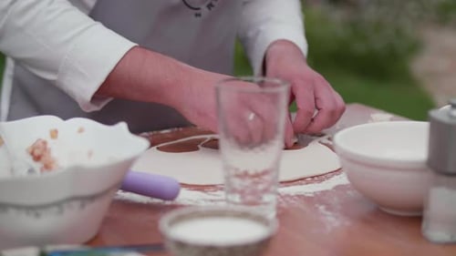 the Cook Makes Dumplings Picks Up Round Pieces of Dough