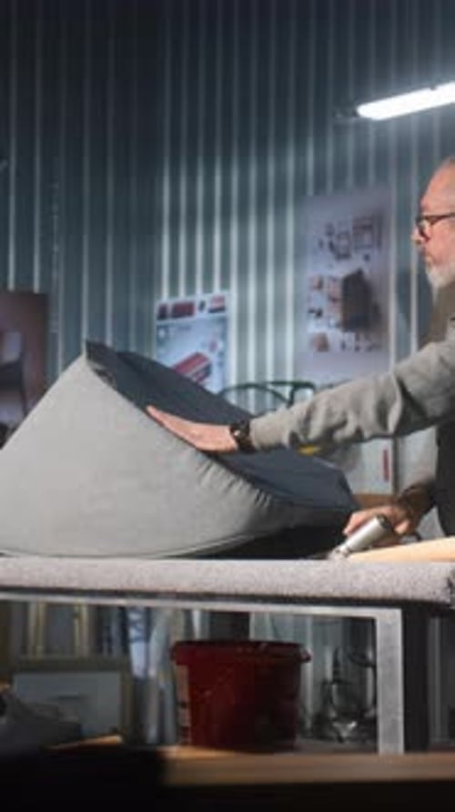 Mature Carpenter Makes Chair Upholstery in Furniture Workshop