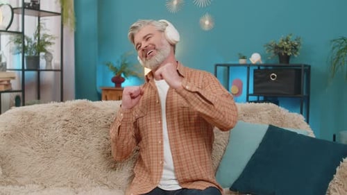 Man Listening to Music and Dancing on Sofa