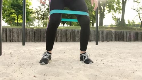 Woman Exercising with Resistance Band Outdoors