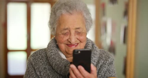 Smiling Senior Woman Using a Mobile Phone