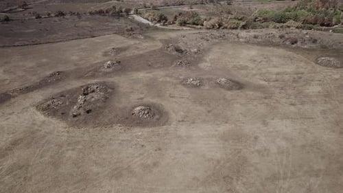 Aerial shot over the burnt land after the huge wildfires in 2021 in Sardinia - the black soil of the