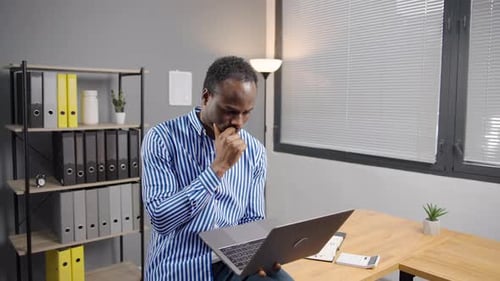 Young Adult Man Working on Laptop Computer