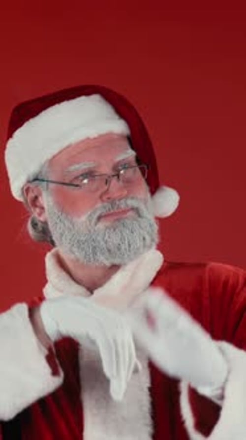 Santa Claus Portrait Against Red Backdrop