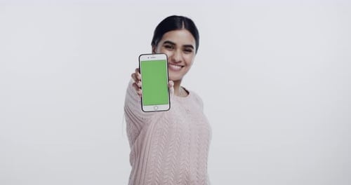 Woman, show phone and green screen in studio with smile on face for promo