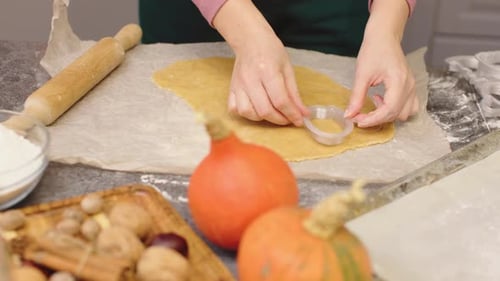 Hands Cutting Holiday Cookies with a Cutter
